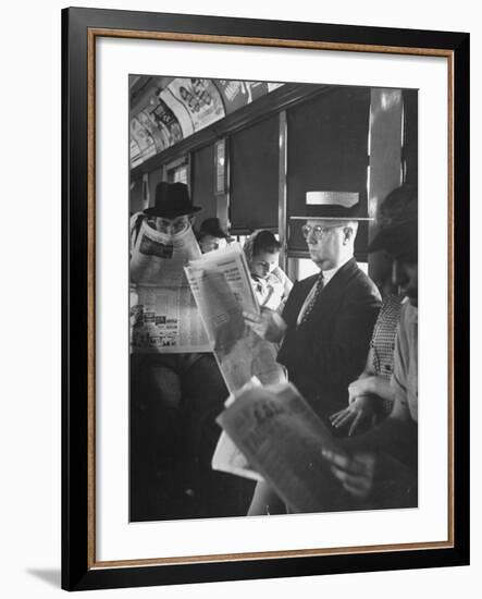 Commuters Sitting on a Train and Reading the Chicago Tribune-Charles E^ Steinheimer-Framed Photographic Print