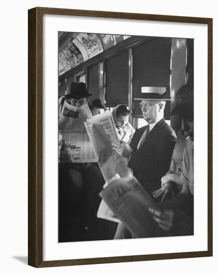 Commuters Sitting on a Train and Reading the Chicago Tribune-Charles E^ Steinheimer-Framed Photographic Print