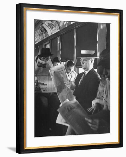 Commuters Sitting on a Train and Reading the Chicago Tribune-Charles E^ Steinheimer-Framed Photographic Print