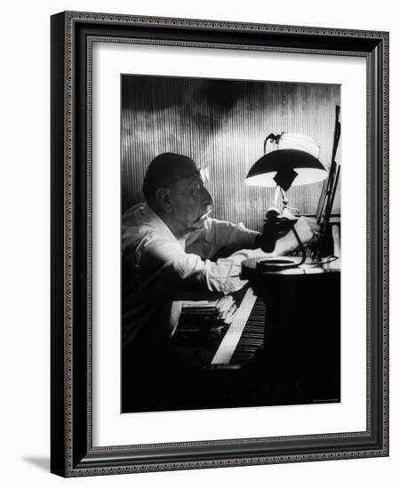 Composer Igor Stravinsky Working at a Piano in an Empty Dance Hall in Venice-Gjon Mili-Framed Premium Photographic Print