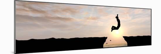 Concept or Conceptual Young Man, Businessman Silhouette Jump Happy from Cliff over Water Gap Sunset-bestdesign36-Mounted Photographic Print