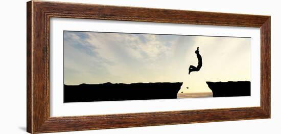 Concept or Conceptual Young Man, Businessman Silhouette Jump Happy from Cliff over Water Gap Sunset-bestdesign36-Framed Photographic Print