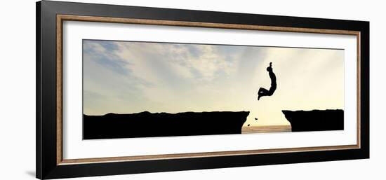 Concept or Conceptual Young Man, Businessman Silhouette Jump Happy from Cliff over Water Gap Sunset-bestdesign36-Framed Photographic Print