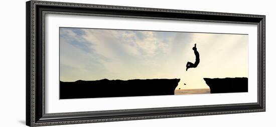 Concept or Conceptual Young Man, Businessman Silhouette Jump Happy from Cliff over Water Gap Sunset-bestdesign36-Framed Photographic Print