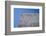 Concrete grey wall with structure and inclusions as a background in front of sky blue cloudless-Axel Killian-Framed Photographic Print