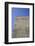 Concrete grey wall with structure and inclusions as a background in front of sky blue cloudless-Axel Killian-Framed Photographic Print