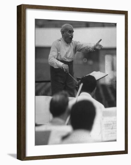 Conductor Arturo Toscanini, Singing and Shouting Instructions While Rehearsing His Men in a Gym-Joe Scherschel-Framed Premium Photographic Print