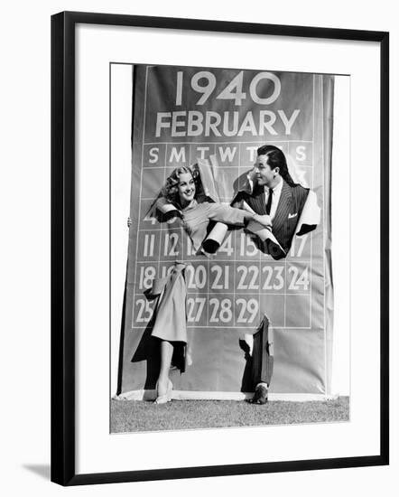 Couple Bursting Through Leap Year Calendar-null-Framed Photo