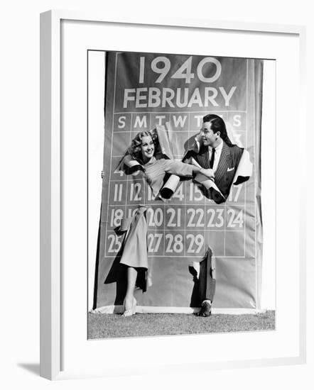 Couple Bursting Through Leap Year Calendar-null-Framed Photo