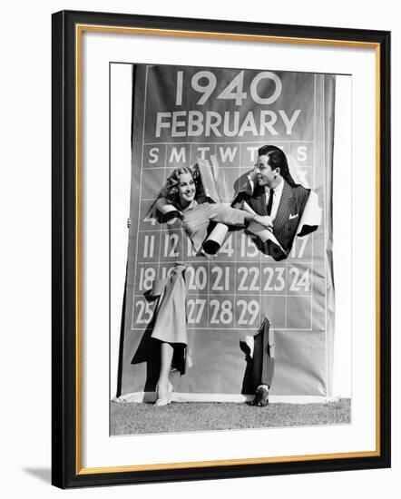 Couple Bursting Through Leap Year Calendar-null-Framed Photo