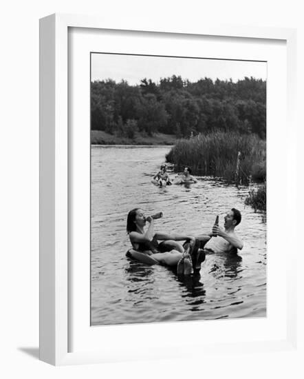 Couple Drinking Beer at Inner Tube Floating Party on the Apple River-Alfred Eisenstaedt-Framed Photographic Print