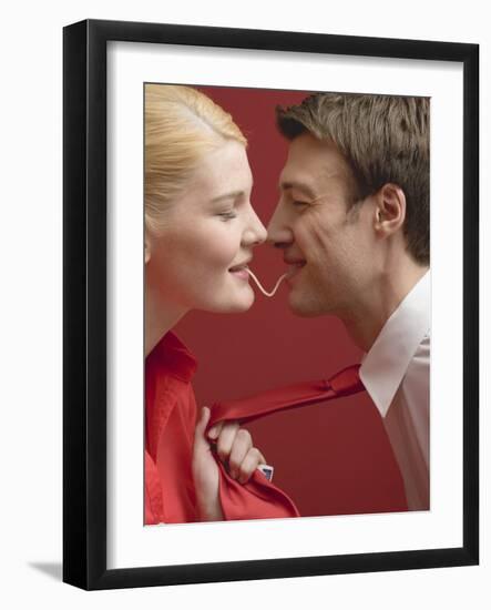 Couple Eating a Strand of Spaghetti from Both Ends-null-Framed Photographic Print