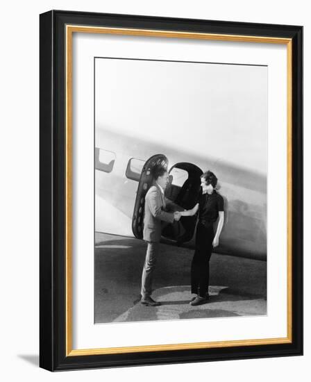 Couple Greeting Each Other at a Small Airplane-null-Framed Photo