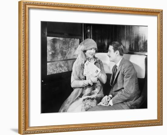 Couple in a Compartment of a Train Looking and Talking with Each Other-null-Framed Photo