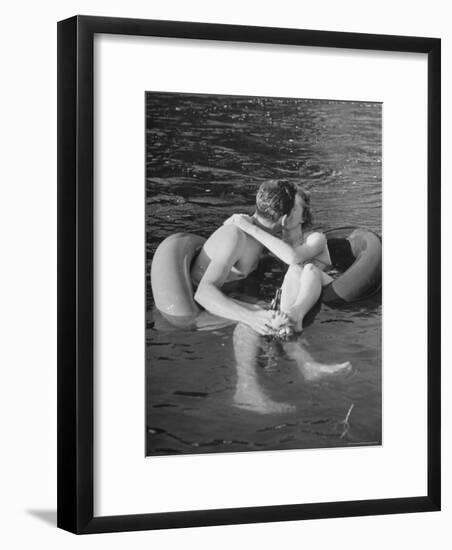 Couple Kissing While Inner Tube Floating-Alfred Eisenstaedt-Framed Photographic Print