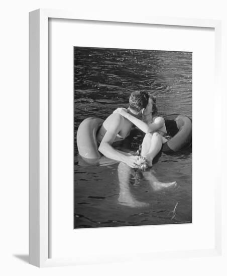 Couple Kissing While Inner Tube Floating-Alfred Eisenstaedt-Framed Photographic Print