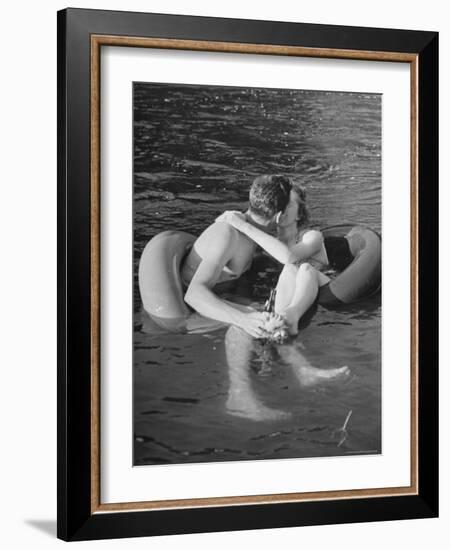 Couple Kissing While Inner Tube Floating-Alfred Eisenstaedt-Framed Photographic Print