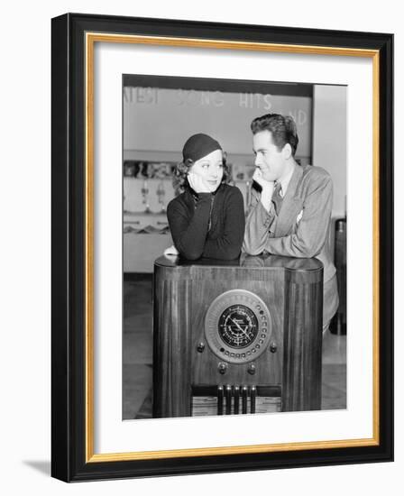 Couple Leaning on a Radio and Looking at Each Other-null-Framed Photo