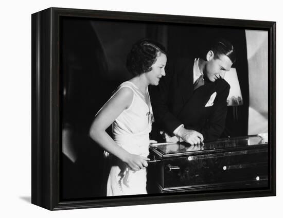 Couple Playing with Pinball Machine-null-Framed Stretched Canvas