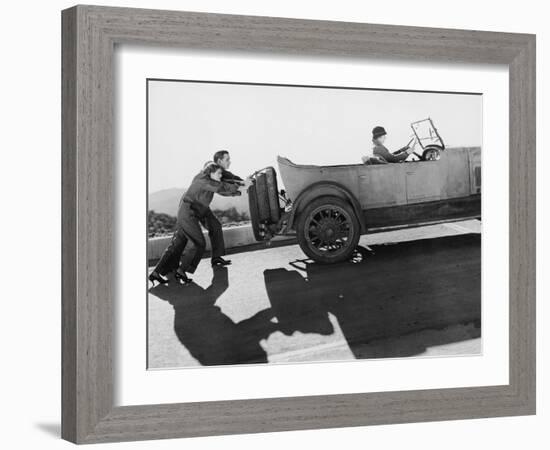 Couple Pushing Woman in Car Up Hill-null-Framed Photo
