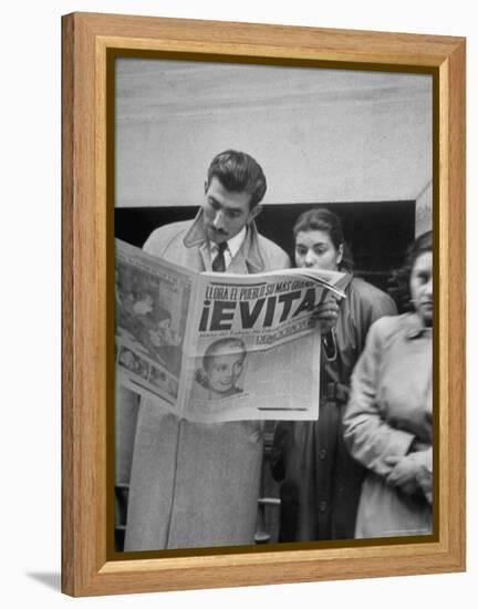 Couple Reading Newspaper Account of the Death of Evita Peron at 33 from Cancer-Alfred Eisenstaedt-Framed Premier Image Canvas