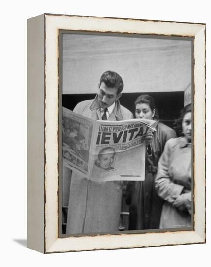 Couple Reading Newspaper Account of the Death of Evita Peron at 33 from Cancer-Alfred Eisenstaedt-Framed Premier Image Canvas