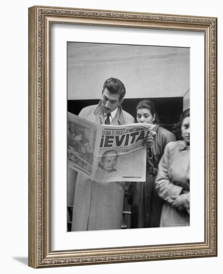 Couple Reading Newspaper Account of the Death of Evita Peron at 33 from Cancer-Alfred Eisenstaedt-Framed Photographic Print