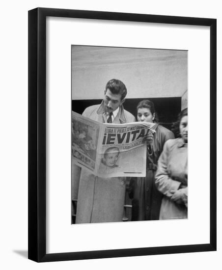 Couple Reading Newspaper Account of the Death of Evita Peron at 33 from Cancer-Alfred Eisenstaedt-Framed Photographic Print