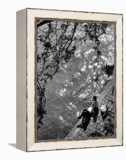 Couple Relaxing on Bank of Seine Near Notre Dame Cathedral During Lunch Hour-Alfred Eisenstaedt-Framed Premier Image Canvas