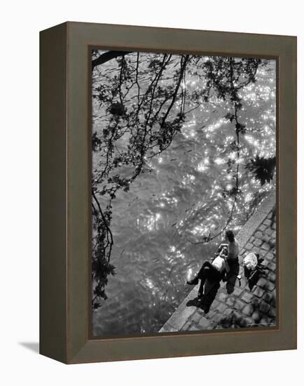 Couple Relaxing on Bank of Seine Near Notre Dame Cathedral During Lunch Hour-Alfred Eisenstaedt-Framed Premier Image Canvas