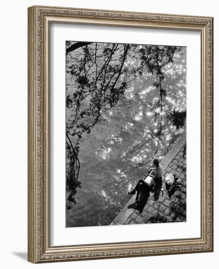 Couple Relaxing on Bank of Seine Near Notre Dame Cathedral During Lunch Hour-Alfred Eisenstaedt-Framed Photographic Print