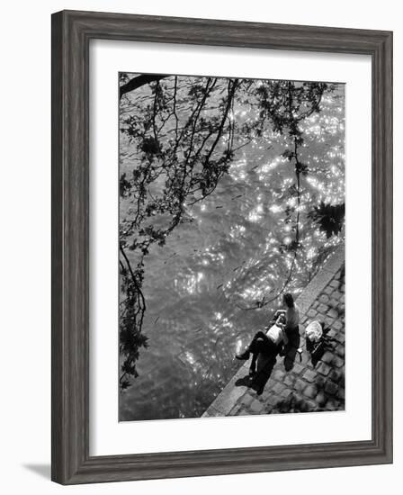 Couple Relaxing on Bank of Seine Near Notre Dame Cathedral During Lunch Hour-Alfred Eisenstaedt-Framed Photographic Print