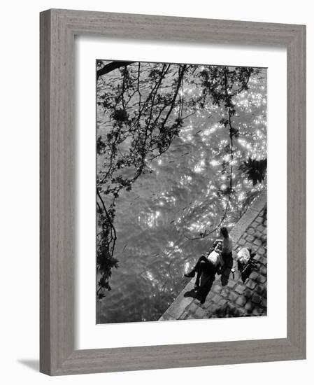 Couple Relaxing on Bank of Seine Near Notre Dame Cathedral During Lunch Hour-Alfred Eisenstaedt-Framed Photographic Print