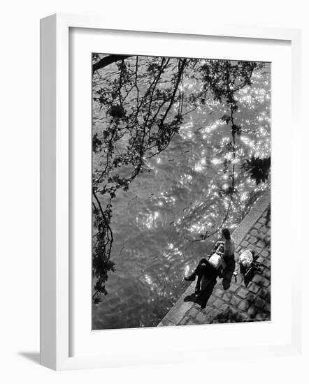 Couple Relaxing on Bank of Seine Near Notre Dame Cathedral During Lunch Hour-Alfred Eisenstaedt-Framed Photographic Print