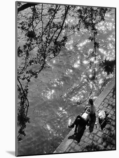 Couple Relaxing on Bank of Seine Near Notre Dame Cathedral During Lunch Hour-Alfred Eisenstaedt-Mounted Photographic Print