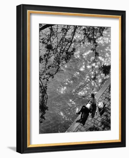 Couple Relaxing on Bank of Seine Near Notre Dame Cathedral During Lunch Hour-Alfred Eisenstaedt-Framed Photographic Print