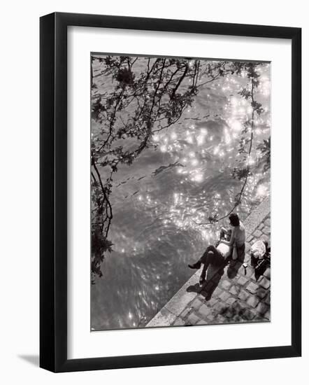 Couple Relaxing on Bank of Seine Near Notre Dame Cathedral During Lunch Hour-Alfred Eisenstaedt-Framed Photographic Print