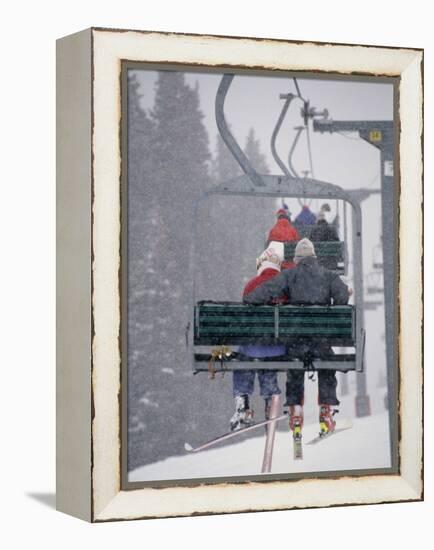 Couple Riding Up the Ski Lift During a Snow Storm, Vail, Colorado, USA-Paul Sutton-Framed Premier Image Canvas