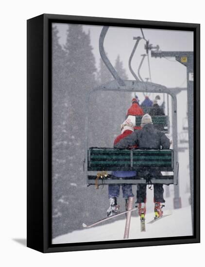 Couple Riding Up the Ski Lift During a Snow Storm, Vail, Colorado, USA-Paul Sutton-Framed Premier Image Canvas