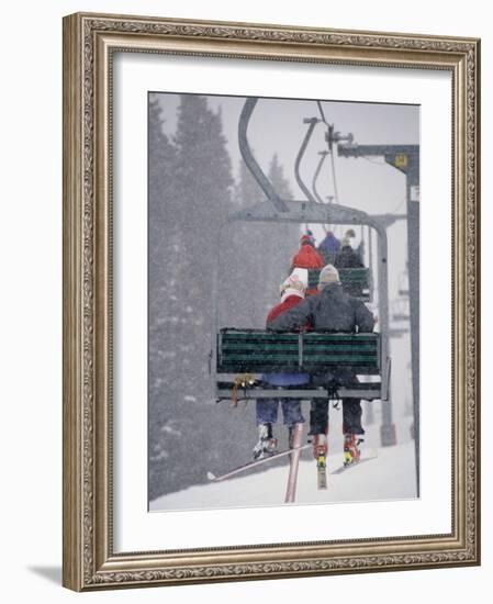 Couple Riding Up the Ski Lift During a Snow Storm, Vail, Colorado, USA-Paul Sutton-Framed Photographic Print