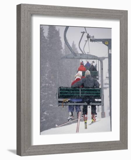 Couple Riding Up the Ski Lift During a Snow Storm, Vail, Colorado, USA-Paul Sutton-Framed Photographic Print