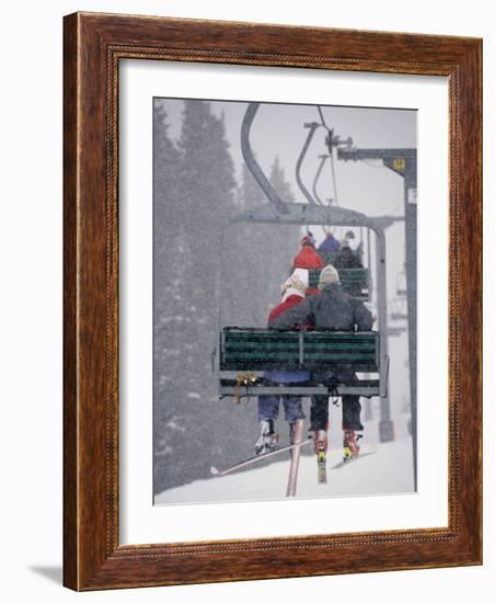 Couple Riding Up the Ski Lift During a Snow Storm, Vail, Colorado, USA-Paul Sutton-Framed Photographic Print