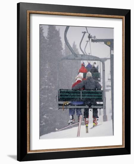 Couple Riding Up the Ski Lift During a Snow Storm, Vail, Colorado, USA-Paul Sutton-Framed Photographic Print