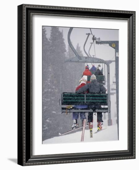 Couple Riding Up the Ski Lift During a Snow Storm, Vail, Colorado, USA-Paul Sutton-Framed Photographic Print