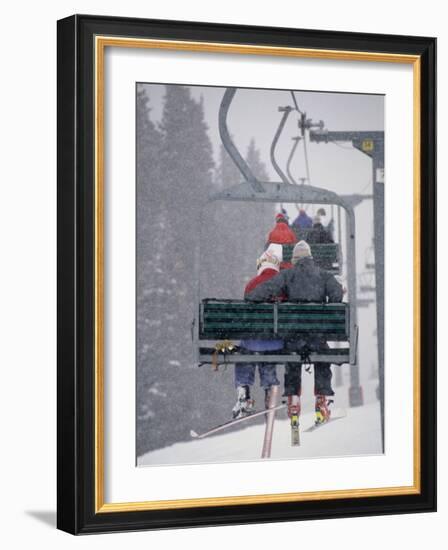 Couple Riding Up the Ski Lift During a Snow Storm, Vail, Colorado, USA-Paul Sutton-Framed Photographic Print