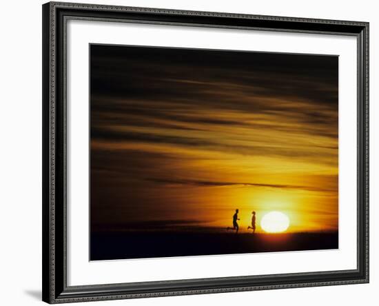 Couple Running at Sunset-null-Framed Photographic Print