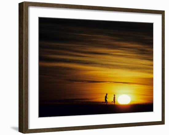 Couple Running at Sunset-null-Framed Photographic Print