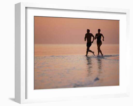 Couple Running on Beach, Felidu Atoll, Maldives-Stuart Westmorland-Framed Photographic Print