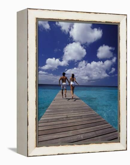 Couple Running on Dock, Curacao, Caribbean-Greg Johnston-Framed Premier Image Canvas