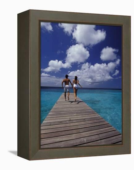 Couple Running on Dock, Curacao, Caribbean-Greg Johnston-Framed Premier Image Canvas